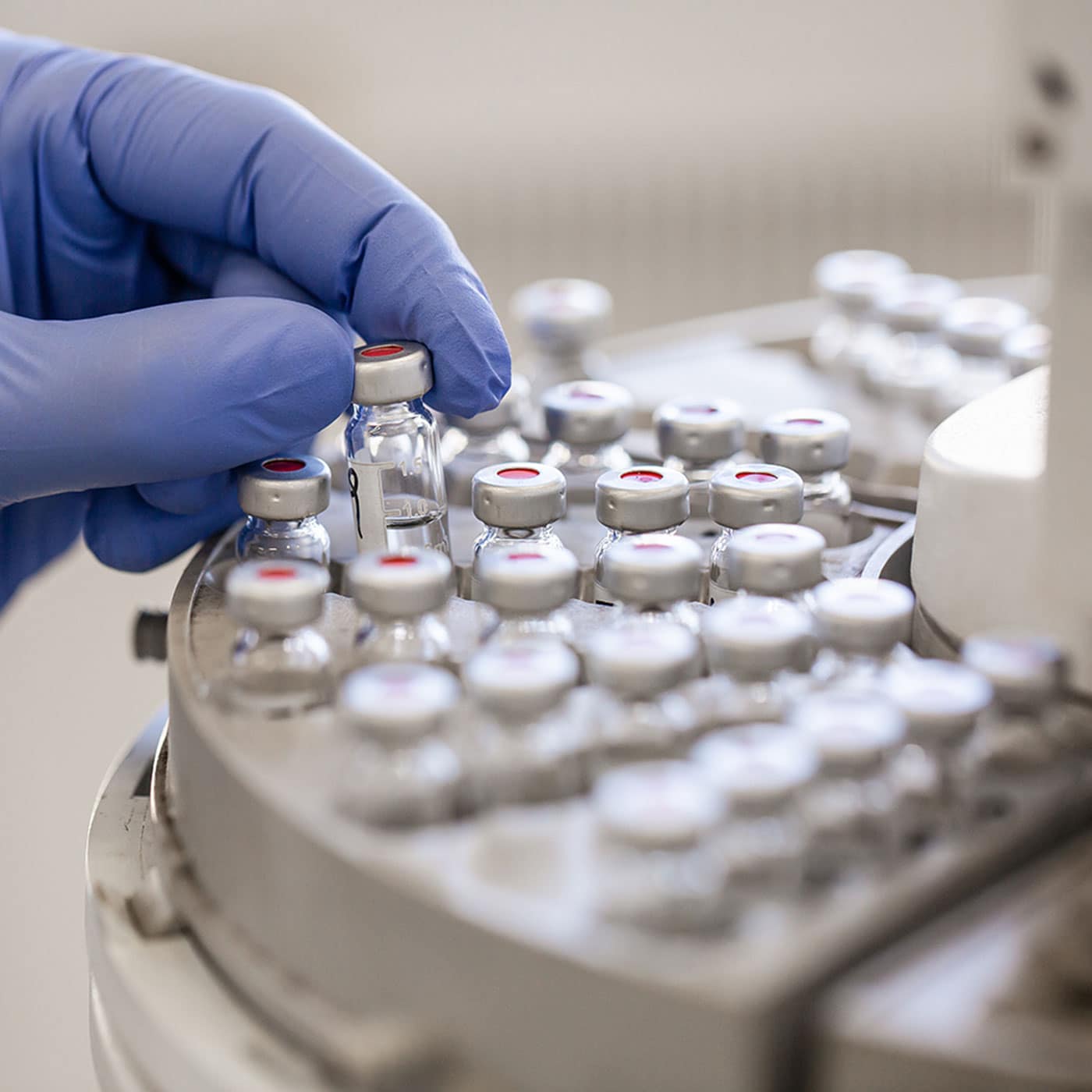 Sample vials being handled by a technician as part of AssureCloud’s ISO-accredited laboratory testing services
